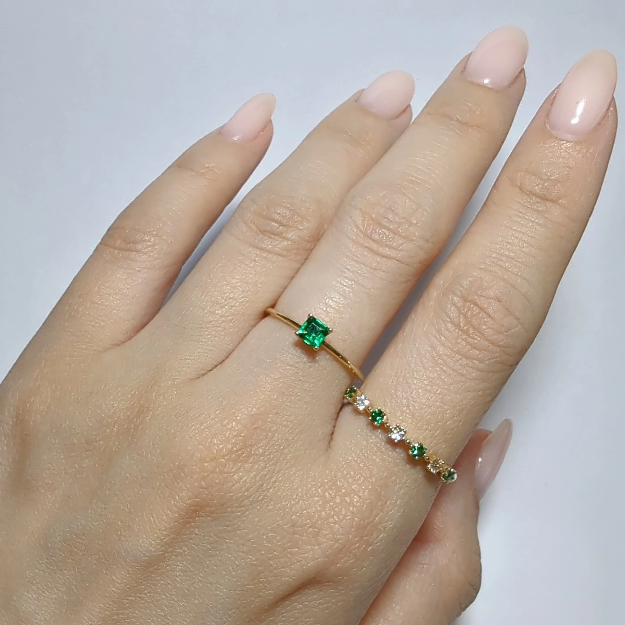 Step-cut emerald solitaire ring